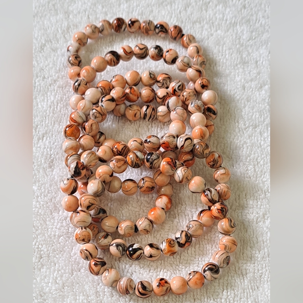 Stretch bracelets ( set of 6 ) Tan Orange Beige and Black New without tags.